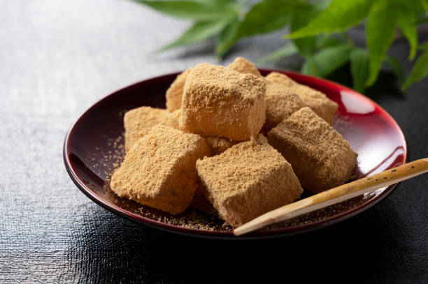 Warabi mochi placed on a black Japanese tray. Warabimochi is a traditional Japanese sweet.