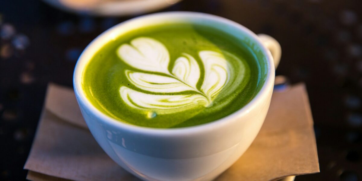 white ceramic teacup filled of matcha tea, matcha