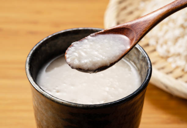 Amazake and a wooden spoon on the table. Amazake is a traditional Japanese sweet drink.